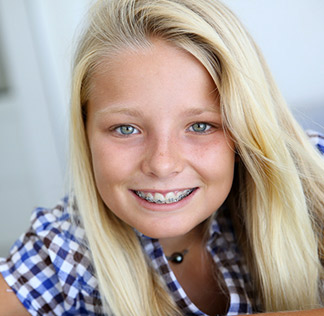 A happy patient smiling with braces
